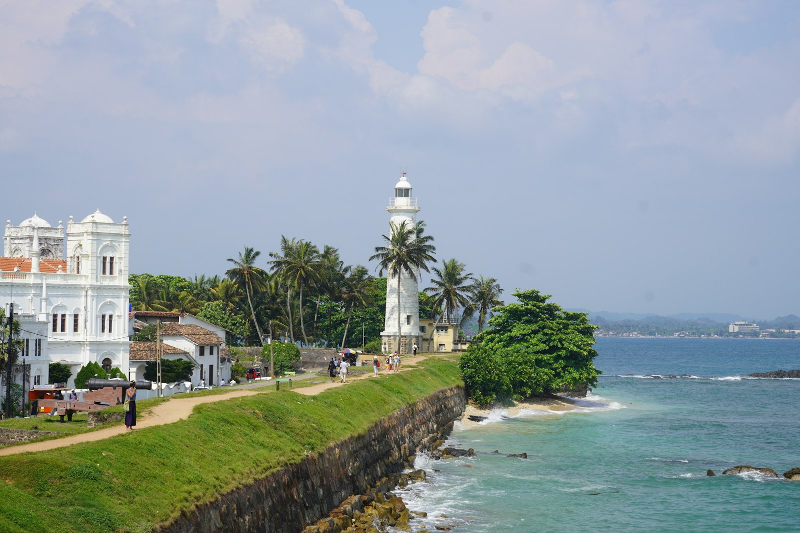 Galle Fort lighthouse and white colonial architecture above turquoise sea on the south coast of Sri Lanka